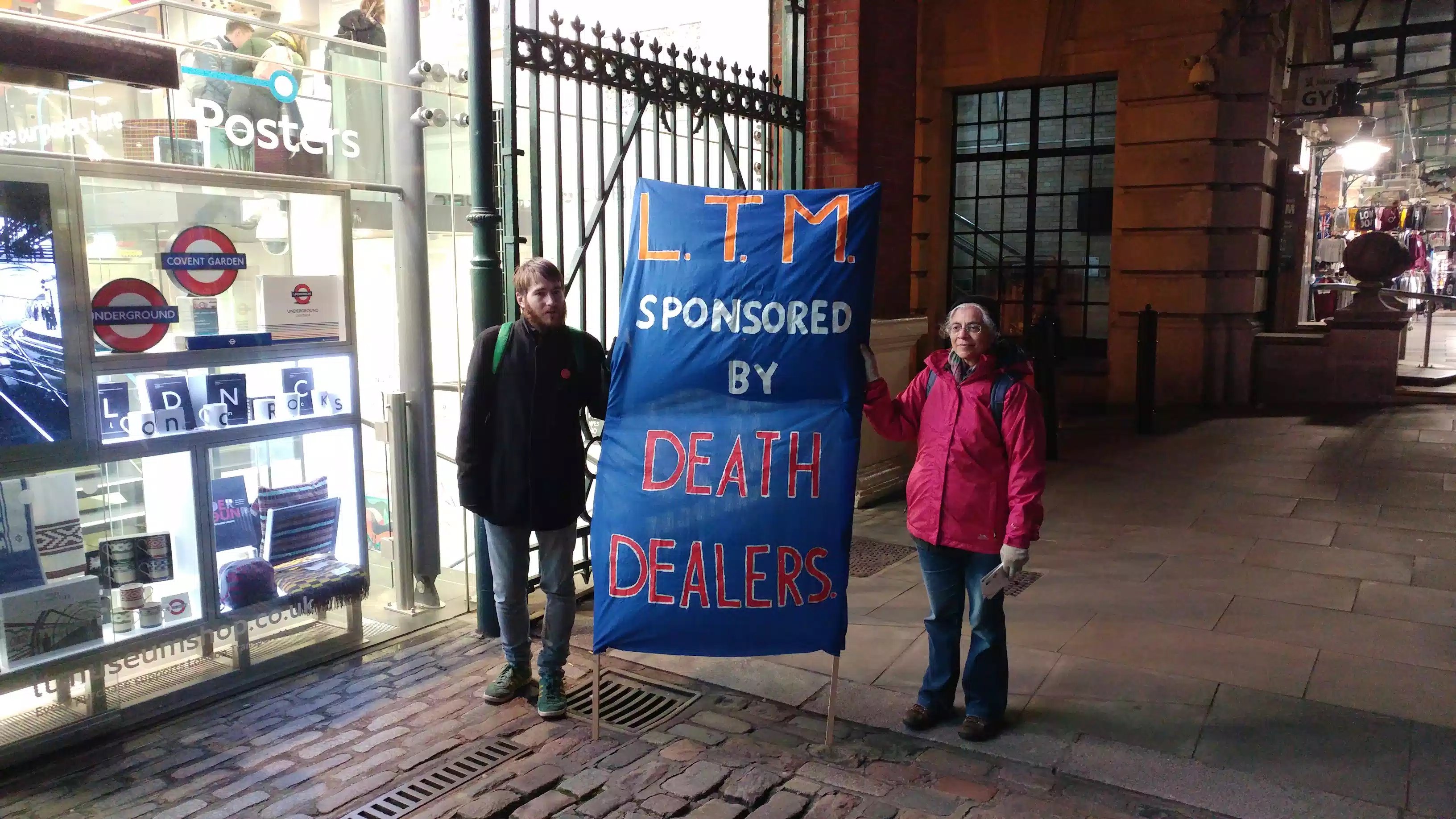 activists hold banner 'LTM- sponosred by death dealers'